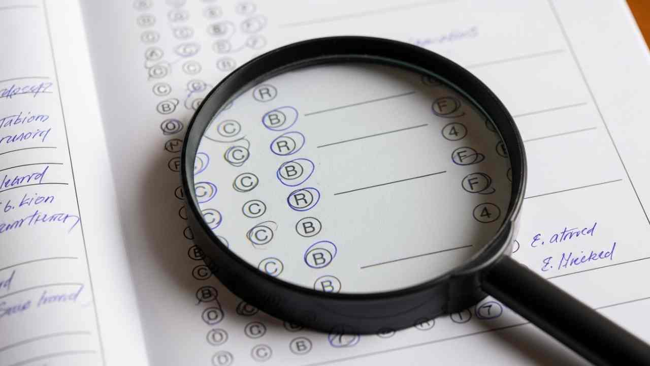Exam Paper With Magnifying Glass